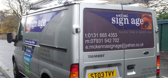 A silver van with vinyl graphics