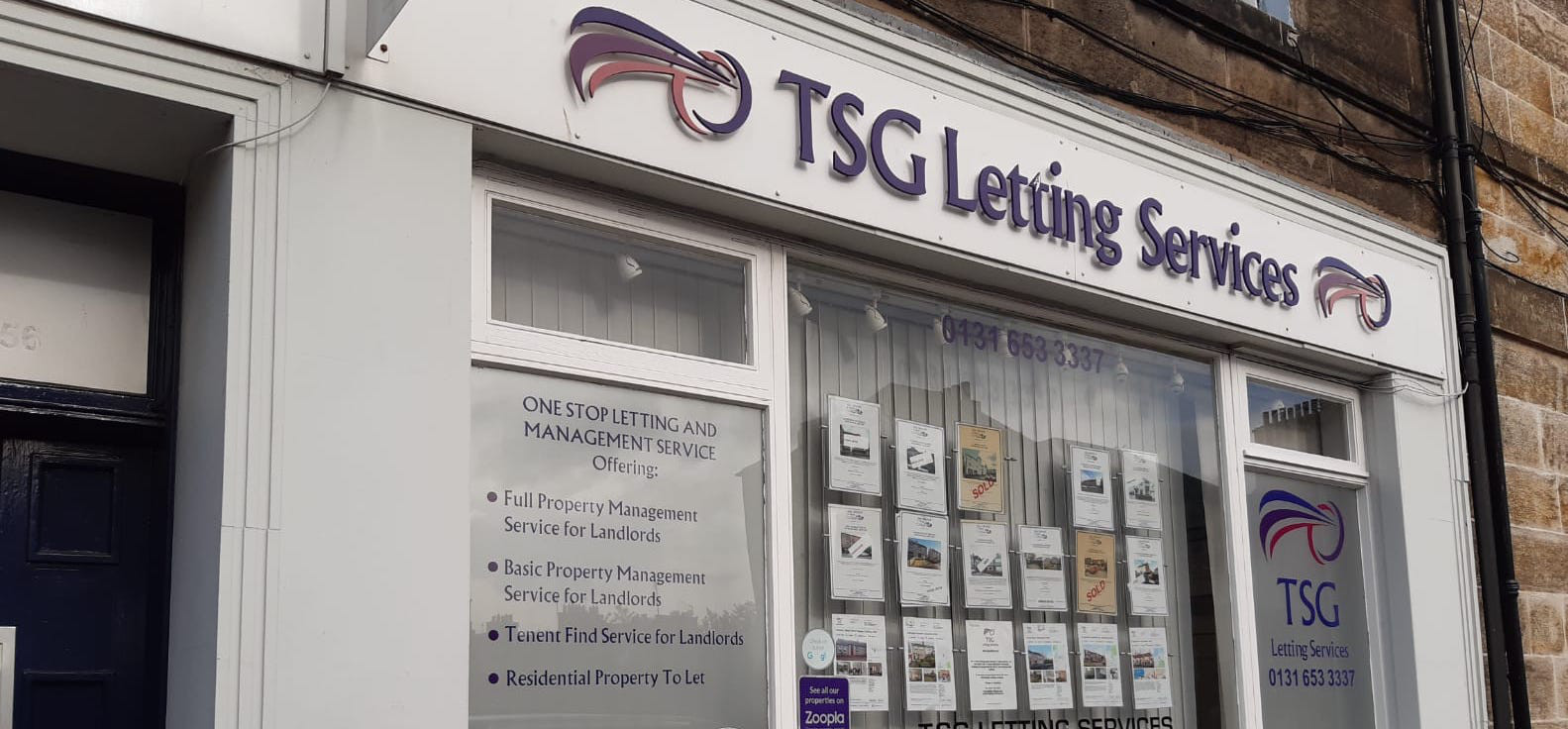 An estate agent shop front with plastic lettering