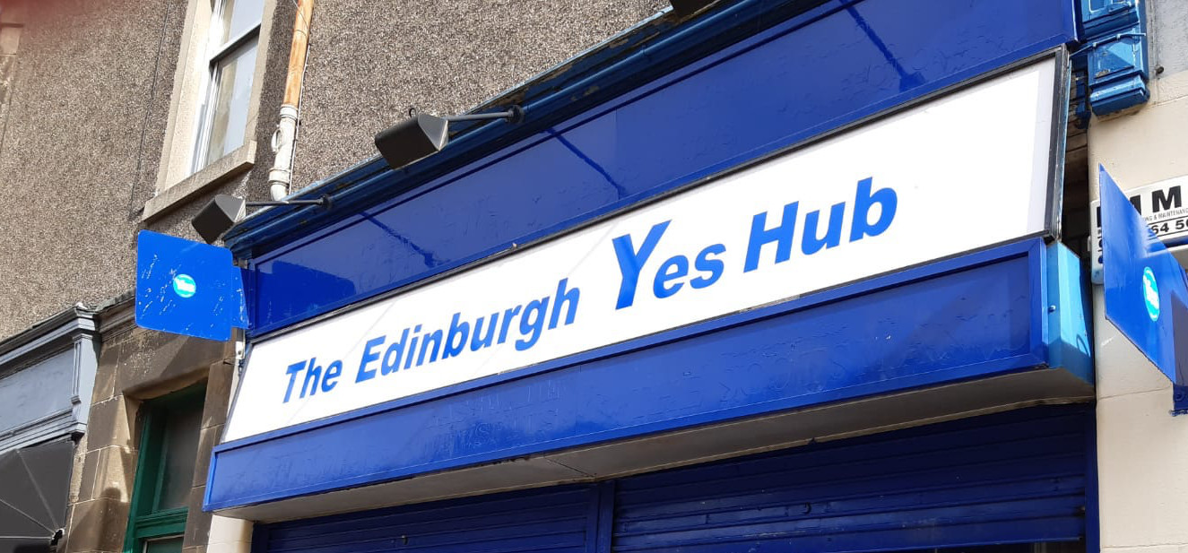 A white shop front with blue writing