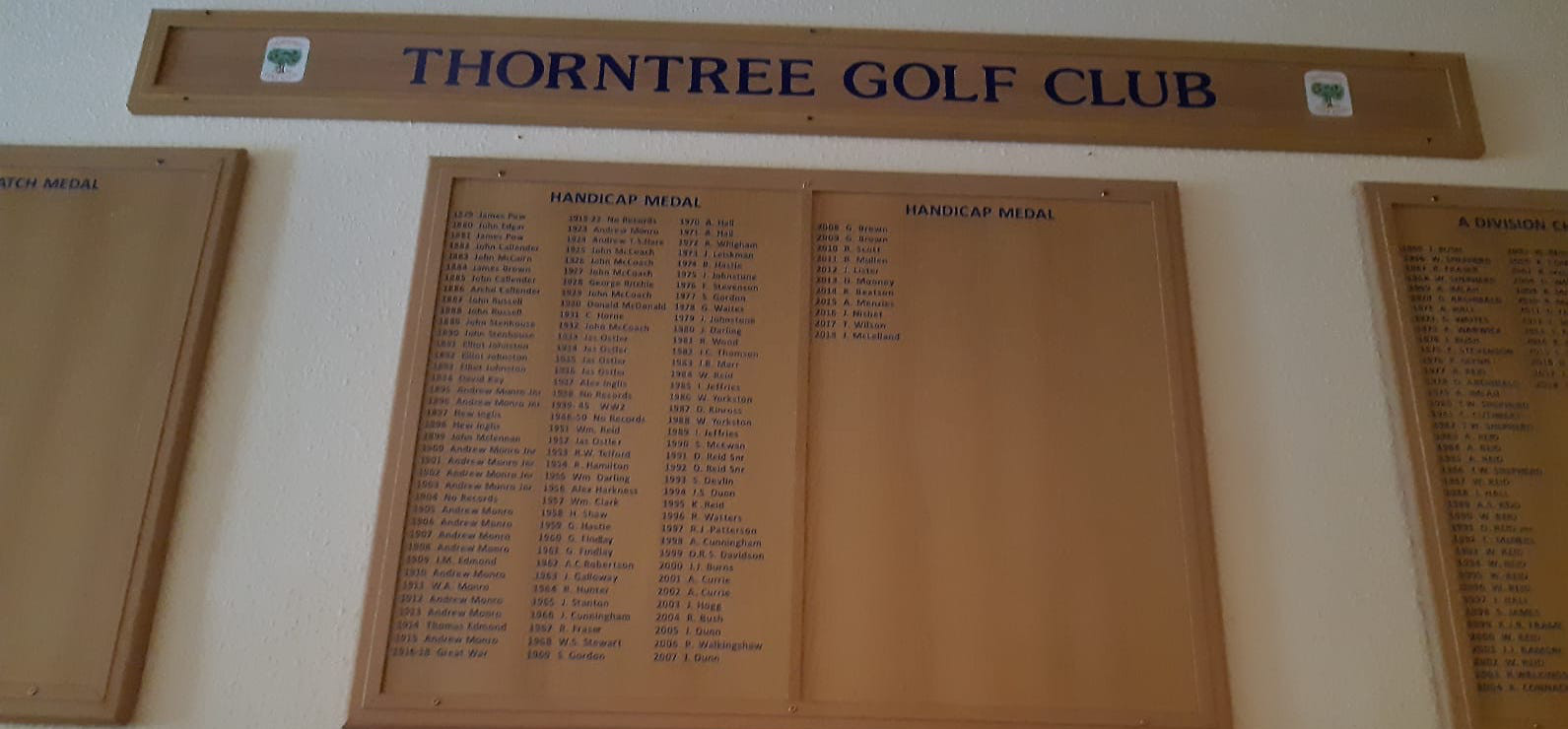 A golf club honours board with previous champions listed